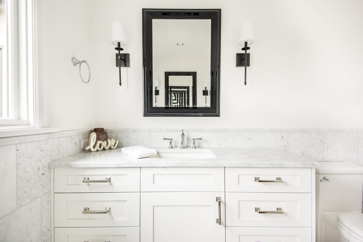 master bathroom en suite master suite black mirror sconces chrome faucets marble carrara wainscot bellmont white shaker cabinets mosaic floor tile border curbless shower